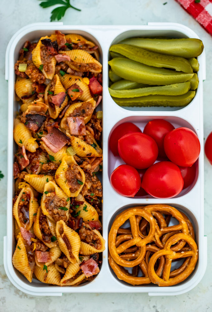 Cheeseburger Pasta with pickles and tomatoes on the side