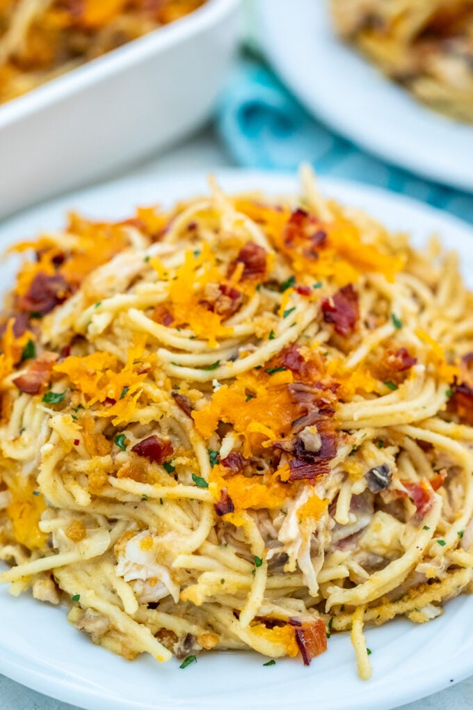 Photo of creamy chicken spaghetti casserole with bacon on a plate.