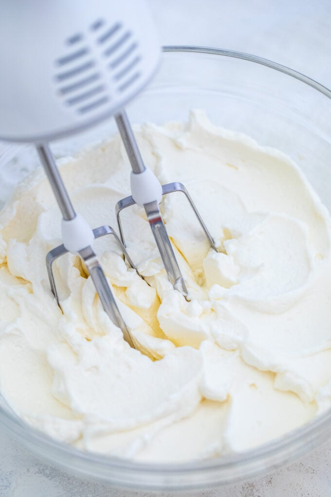 Whipped Cream is sweet, fluffy, and smooth! Learn how to make it at home using minimal ingredients. #whippedcream #cream #frosting #desserts #sweetandsavorymeals