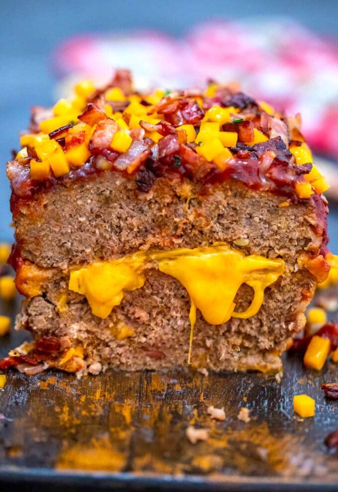 Juicy homemade cheeseburger meatloaf topped with bacon and cheddar cheese. 