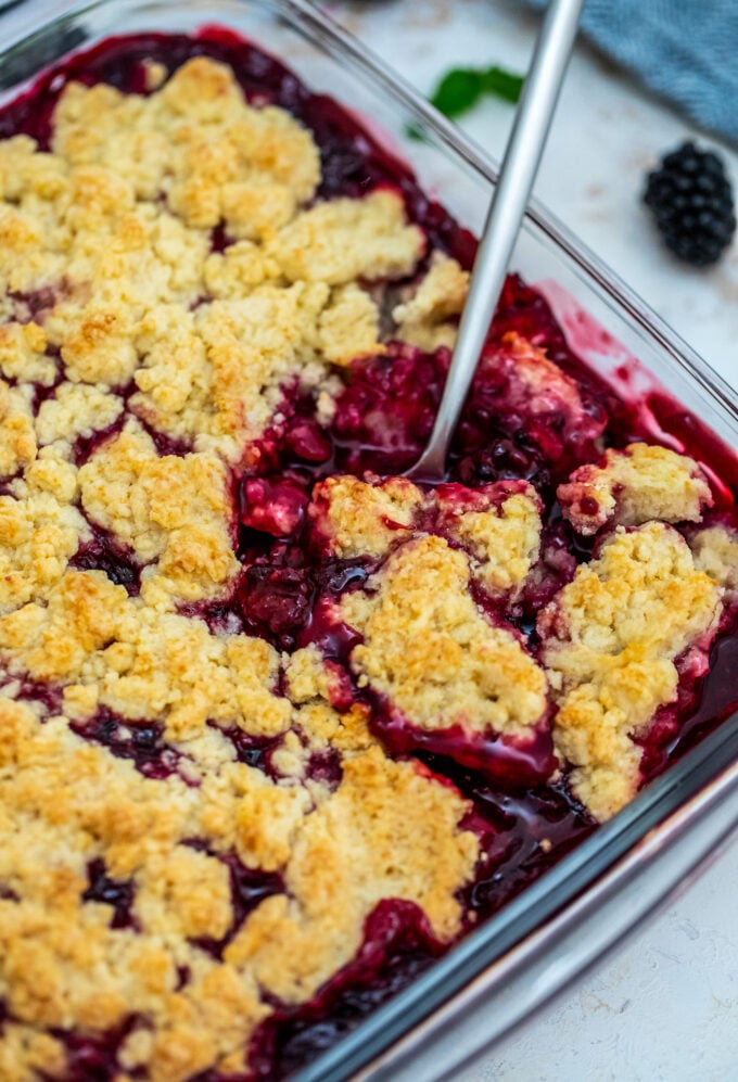 Blackberry Cobbler is a sweet and comforting dessert made with juicy berries and topped with buttery biscuit dough. #cobbler #blackberry #summerrecipes #sweetandsavorymeals #blackberrycobbler