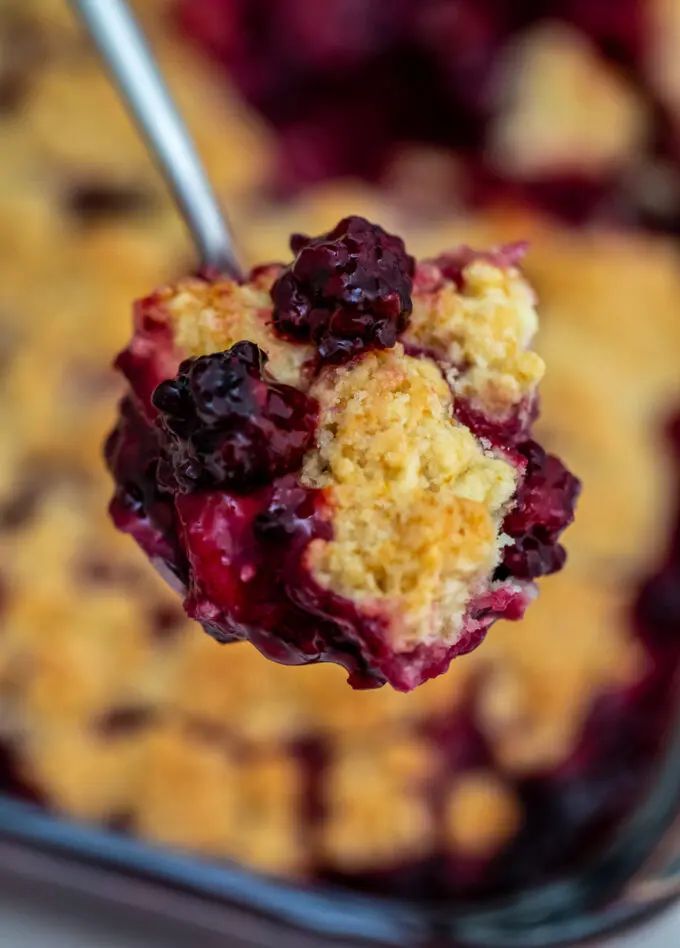 Blackberry Cobbler is a sweet and comforting dessert made with juicy berries and topped with buttery biscuit dough. #cobbler #blackberry #summerrecipes #sweetandsavorymeals #blackberrycobbler
