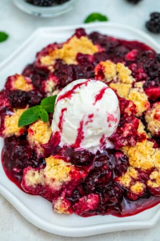 Blackberry Cobbler is a sweet and comforting dessert made with juicy berries and topped with buttery biscuit dough. #cobbler #blackberry #summerrecipes #sweetandsavorymeals #blackberrycobbler