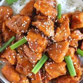 Mongolian chicken with rice and topped with green onions and sesame seeds