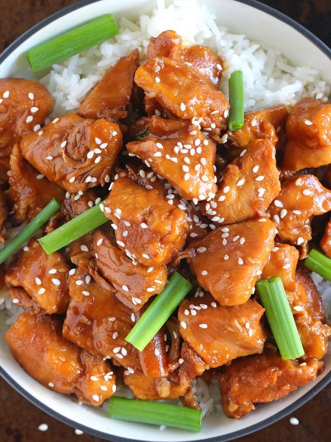 Mongolian chicken with rice and topped with green onions and sesame seeds