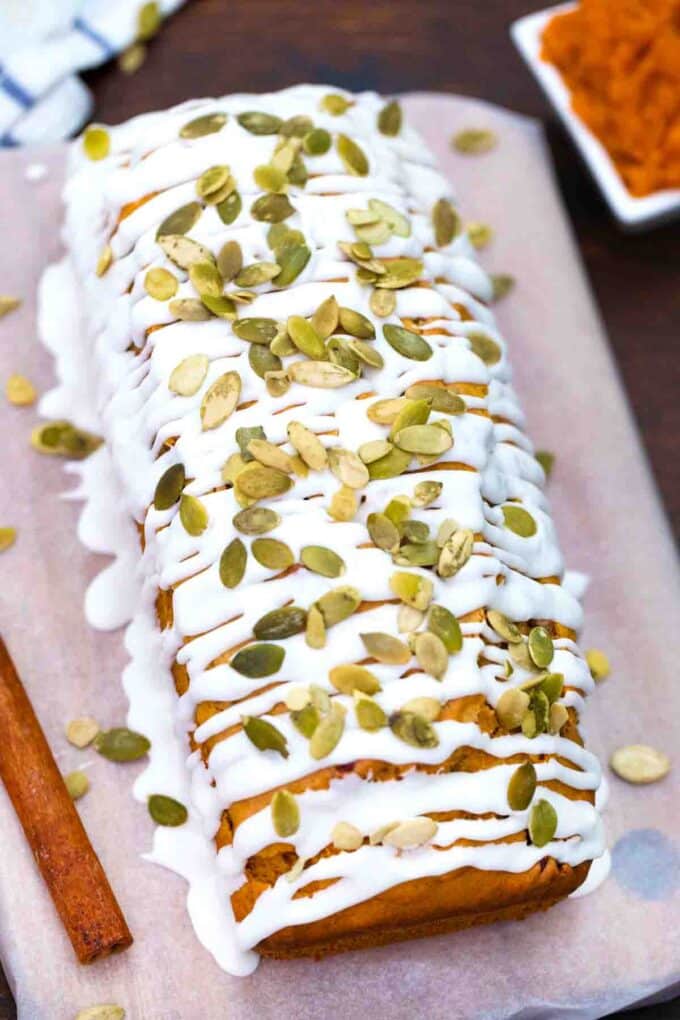 sweet potato bread topped with glaze and pumpkin seeds
