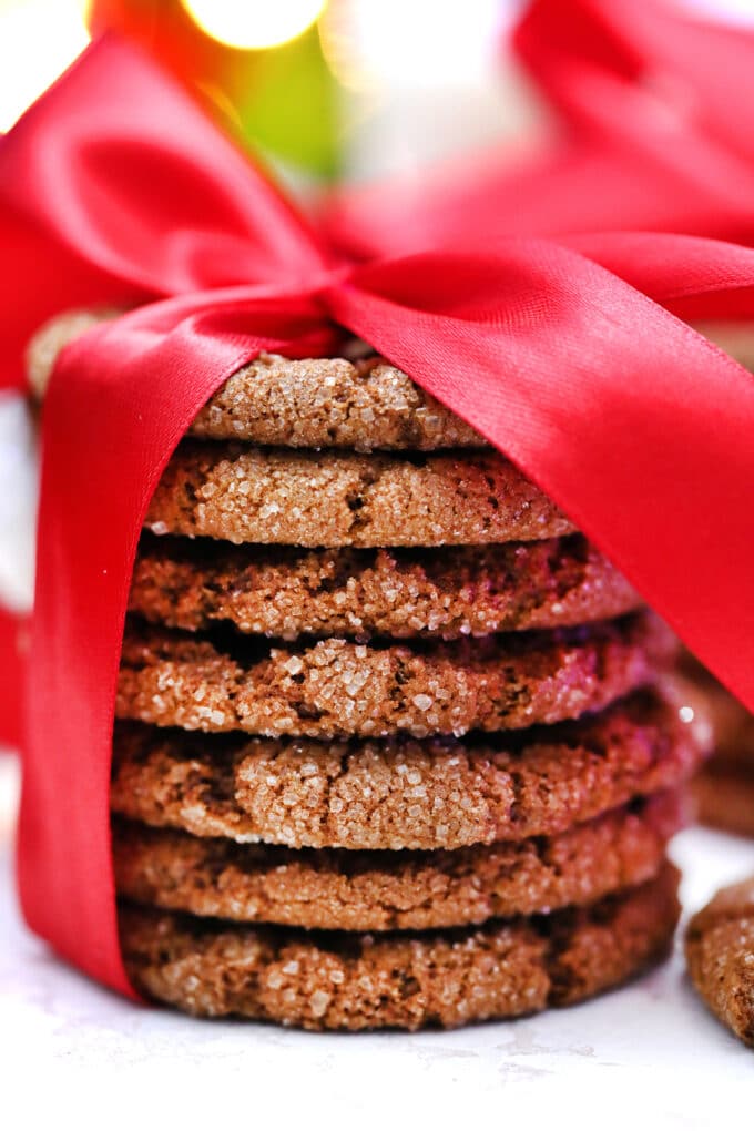 a stack of Molasses Cookies with a red bow tie for hostess gifts