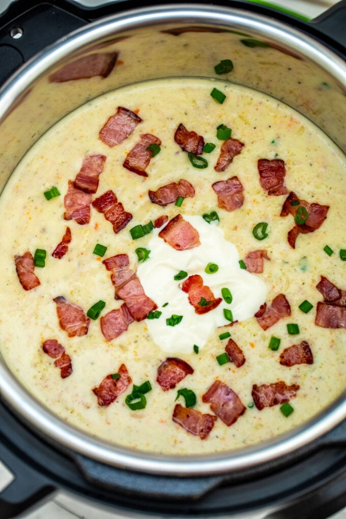 Photo of instant pot ham and potato soup topped with bacon.