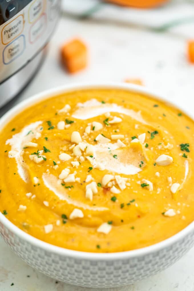 sweet potato soup topped with peanuts and cream