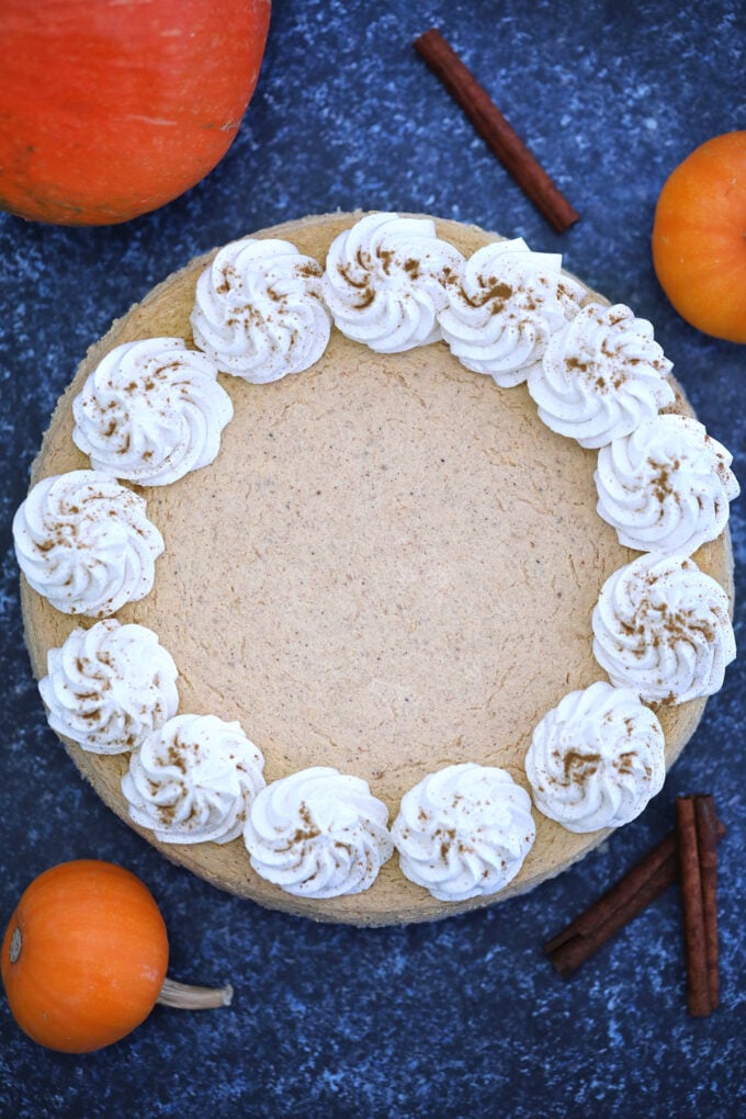 overhead shot of Keto Pumpkin Cheesecake topped with whipped cream roses