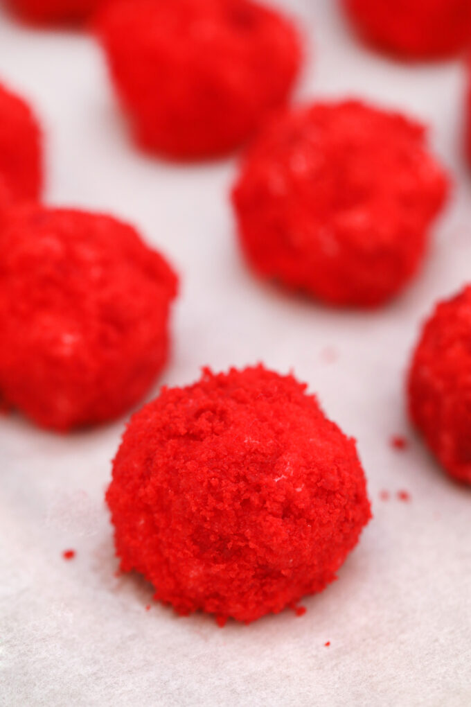 Red Velvet Cheesecake Bites arranged on parchment paper