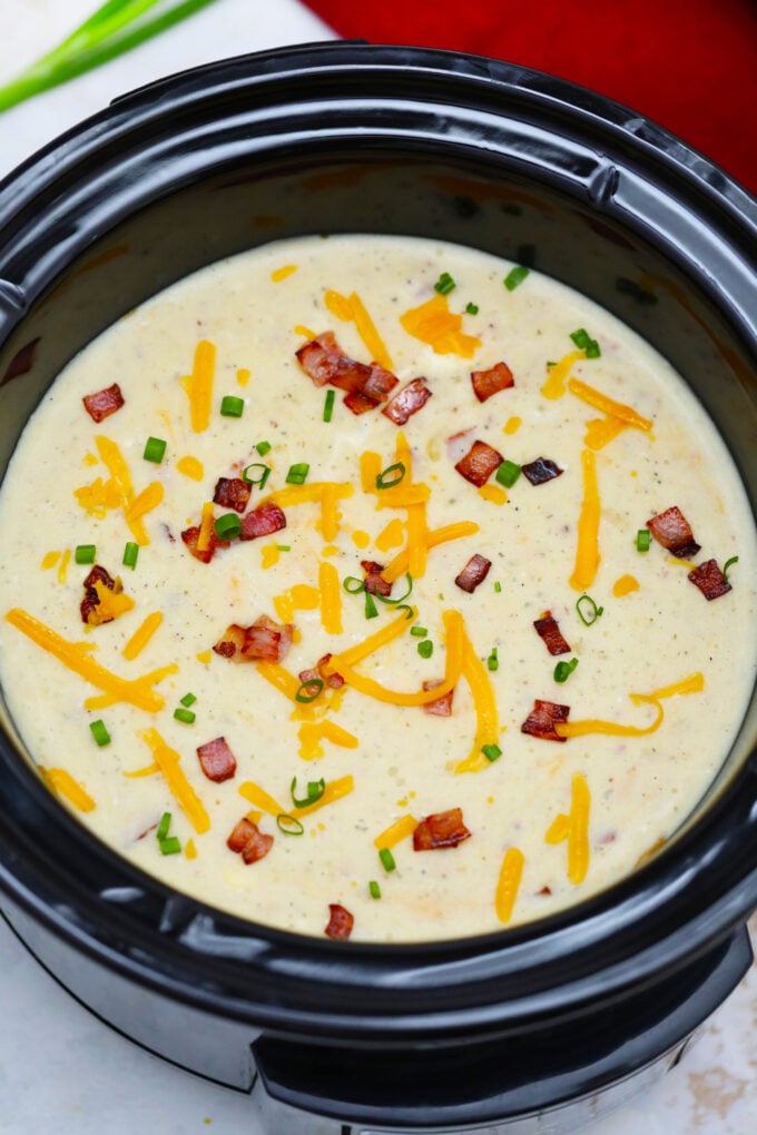 Slow Cooker Bacon Ranch Potato Soup gives a twist to the traditional version. It tastes amazing with the ranch flavor making it definitely worth a try! #soup #crockpotrecipes #slowcookerrecipes #sweetandsavorymeals #souprecipes