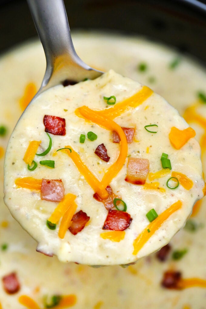 Slow Cooker Bacon Ranch Potato Soup gives a twist to the traditional version. It tastes amazing with the ranch flavor making it definitely worth a try! #soup #crockpotrecipes #slowcookerrecipes #sweetandsavorymeals #souprecipes