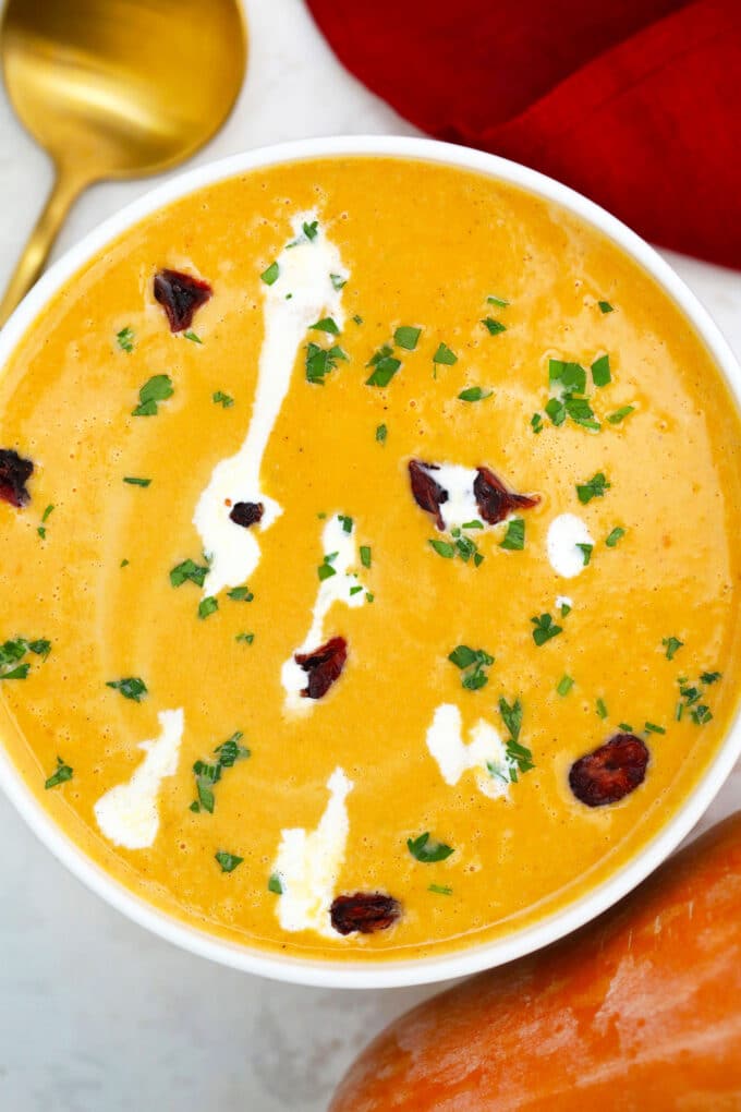 Homemade squash soup with heavy cream in a bowl