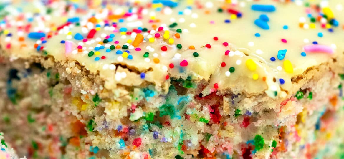 White Chocolate Funfetti Cake is very easy to make, loaded with sprinkles and topped with melted white chocolate, making it a fun and tasty dessert. #funfetticake #cakerecipes #sweetandsavorymeals #birthdaycake #sprinkles