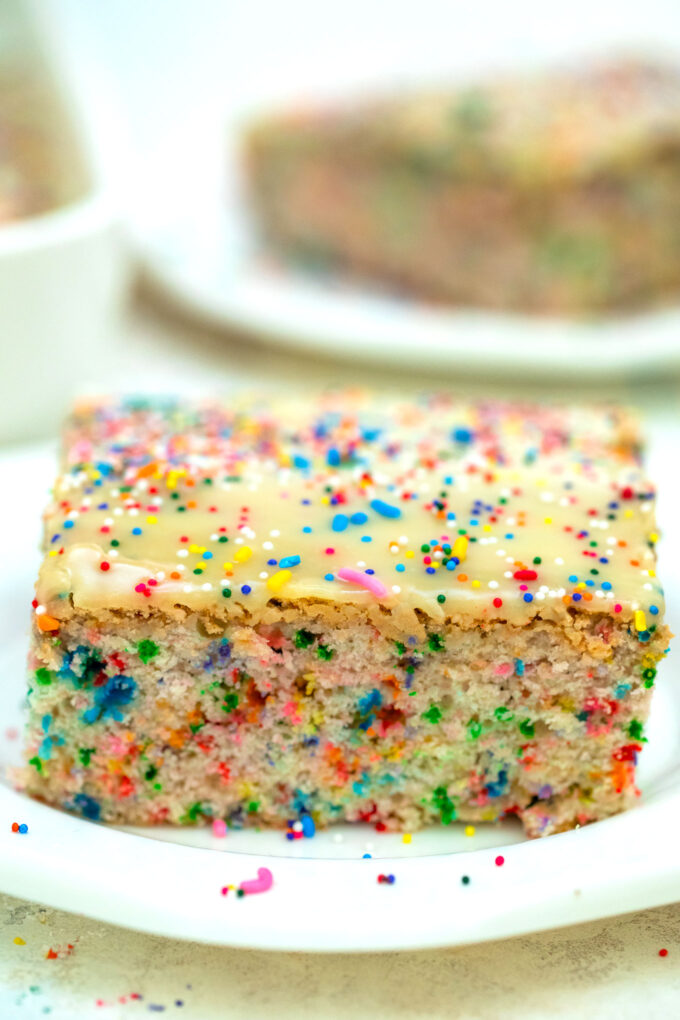 White Chocolate Funfetti Cake is very easy to make, loaded with sprinkles and topped with melted white chocolate, making it a fun and tasty dessert. #funfetticake #cakerecipes #sweetandsavorymeals #birthdaycake #sprinkles