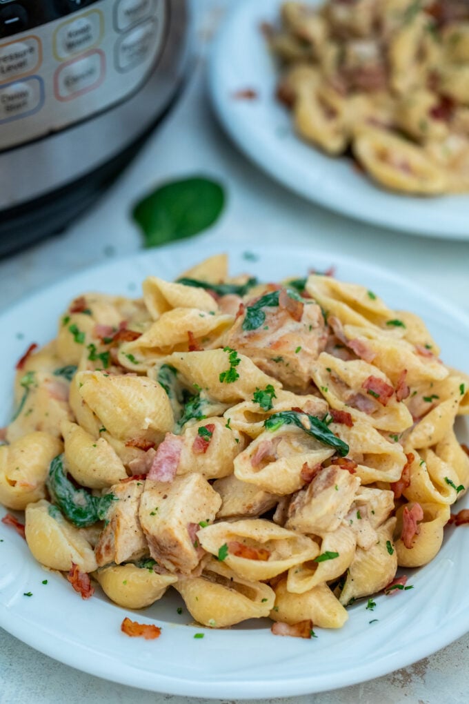 Photo of chicken bacon ranch pasta on a white plate.