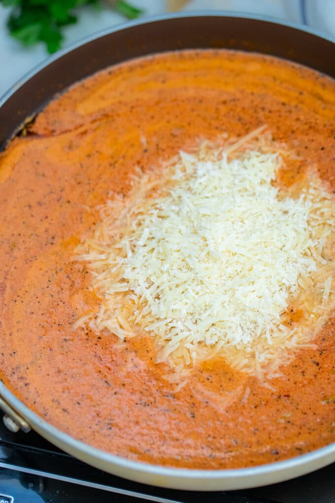 penne alla vodka sauce with shredded cheese.