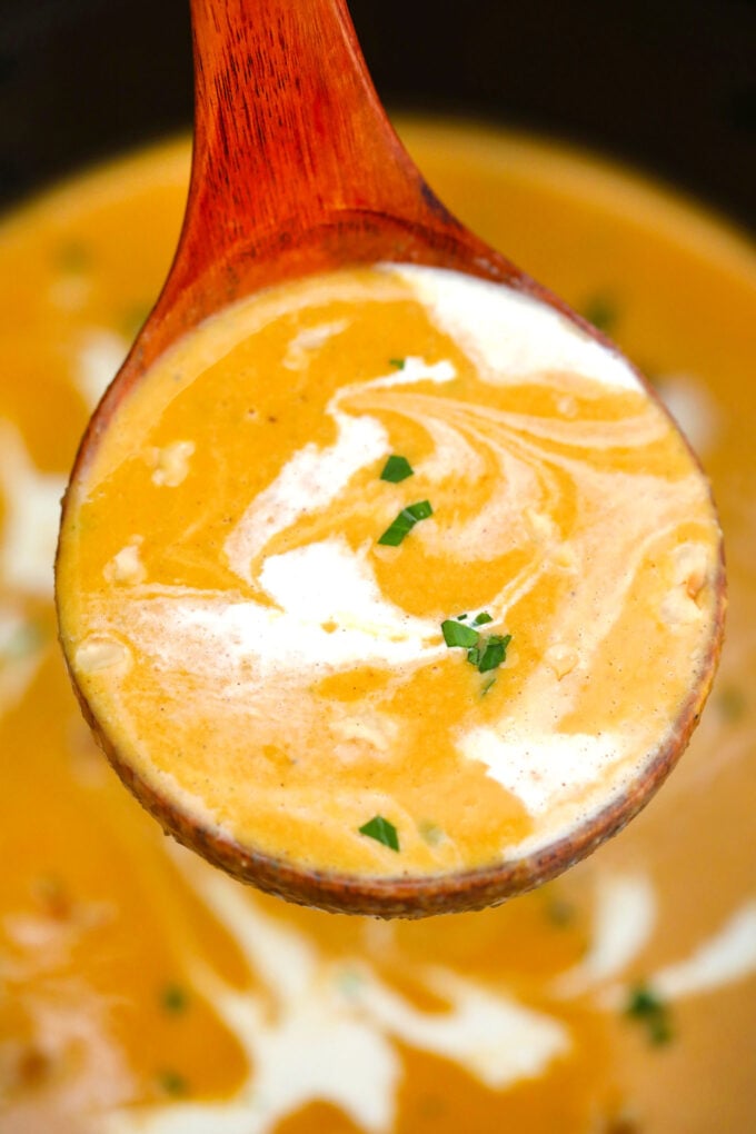 Slow Cooker Roasted Butternut Squash Soup on a wooden spoon 