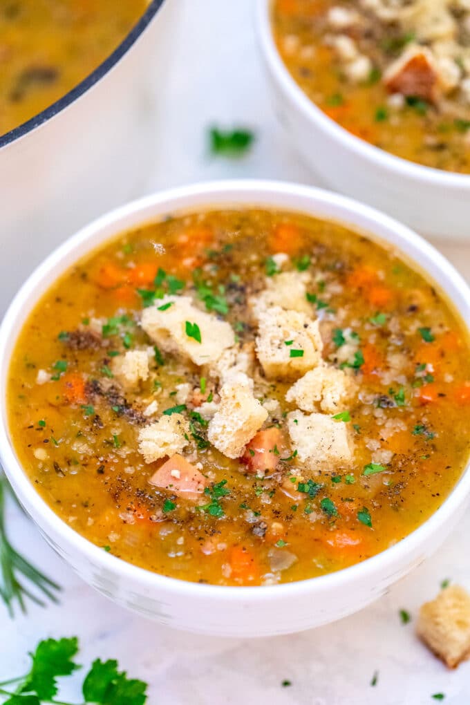 picture of ham spit peas soup on a plate garnished with chopped parsley