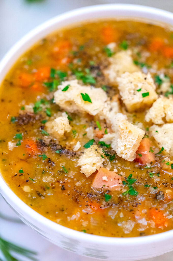 picture of ham and spit soup garnished with croutons and green parsley