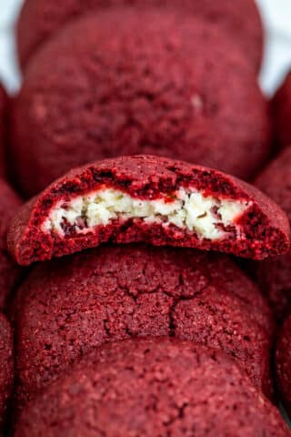 Cheesecake Stuffed Red Velvet Cookies are creamy, festive, and are the perfect treat to have during the holiday season. #cookies #redvelvet #christmasrecipes #valentinesday #sweetandsavorymeals