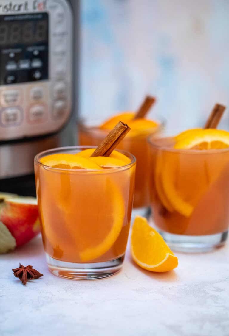 Instant Pot Apple Cider recipe is made with fresh apples, oranges, spices, and maple syrup. #applecider #instantpotrecipes #pressurecookerrecipes #sweetandsavorymeals #drinks