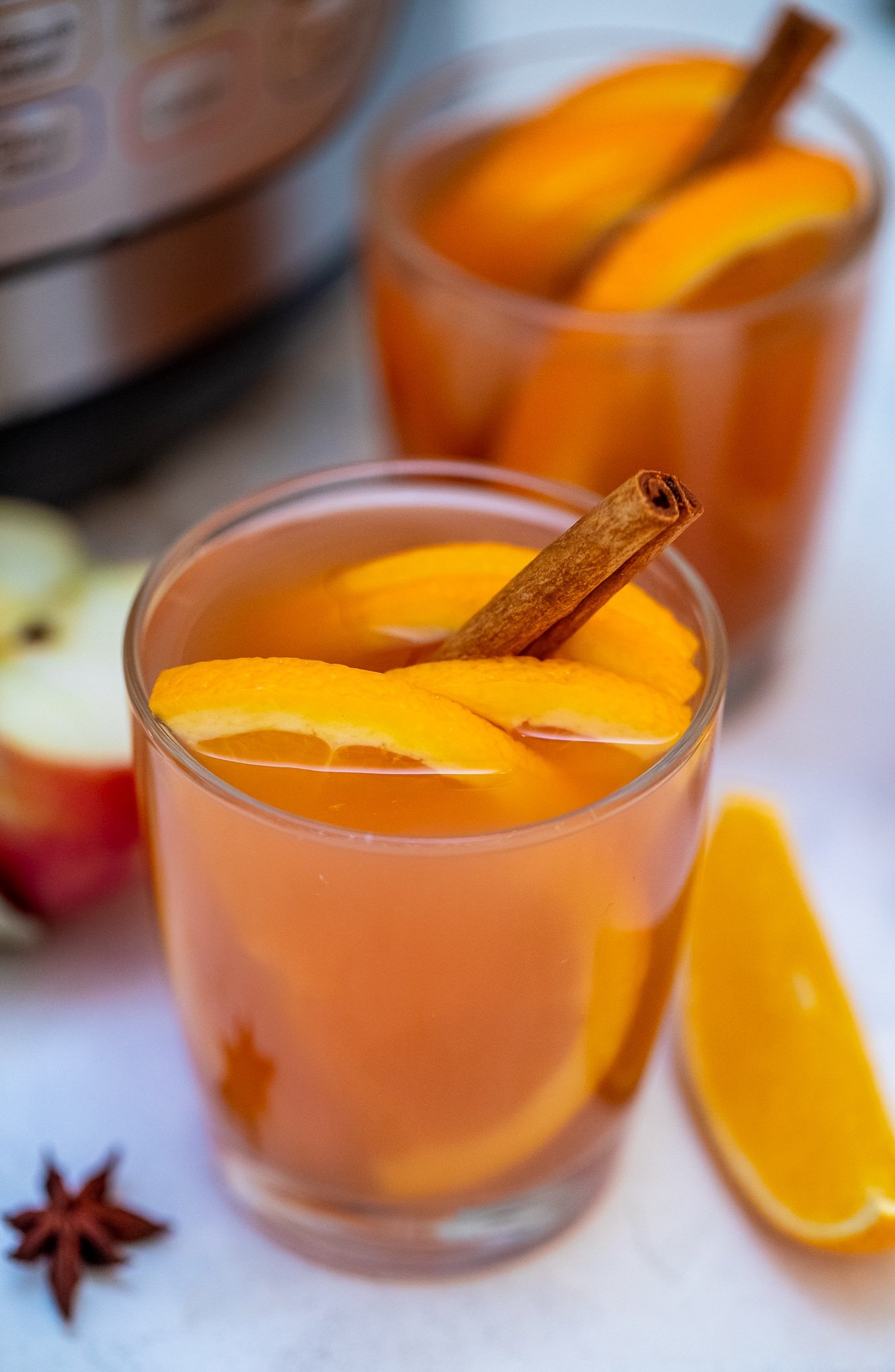 Instant Pot Apple Cider recipe is made with fresh apples, oranges, spices, and maple syrup. #applecider #instantpotrecipes #pressurecookerrecipes #sweetandsavorymeals #drinks