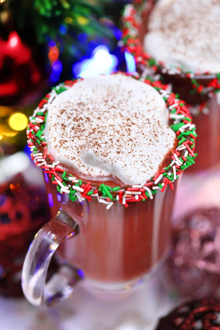 Red Velvet Hot Chocolate is luxurious and rich, topped with a dollop of whipped cream, and the perfect holiday treat. #hotchocolate #redvelvet #christmasrecipes #valentinesdayrecipes #sweetandsavorymeals