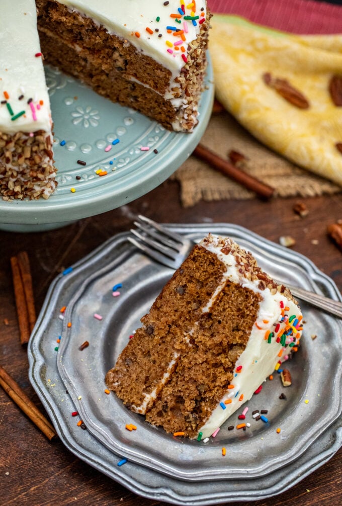 picture of a slice of spice cake topped with sprinkles on a silver plate
