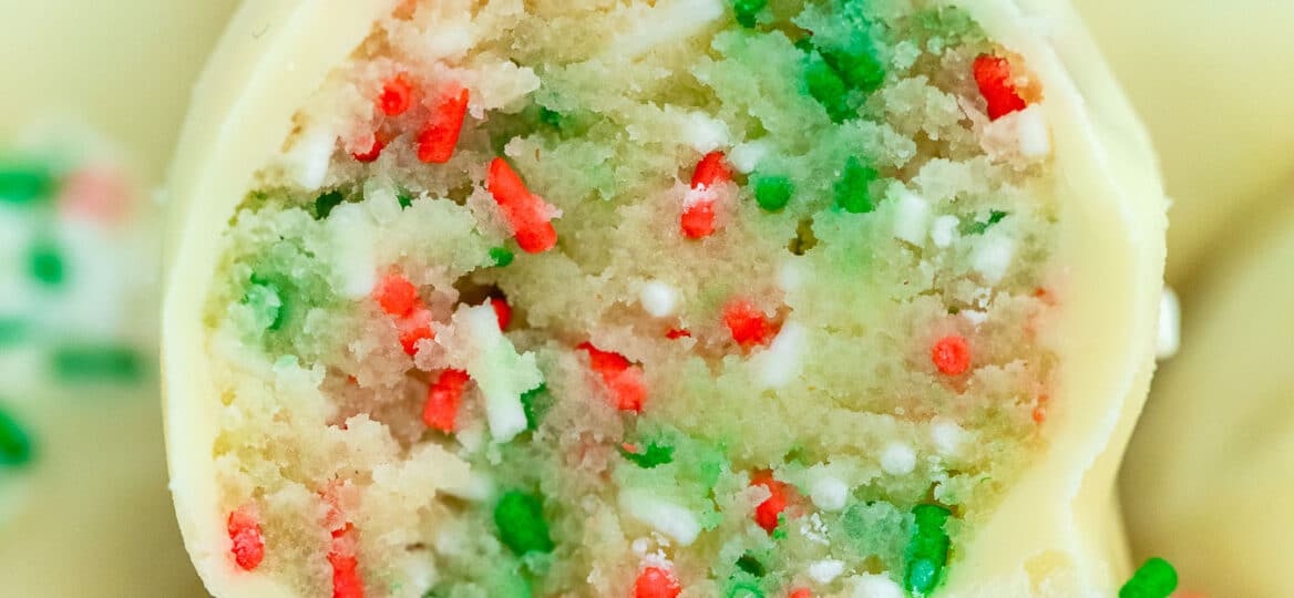 Sugar Cookie Truffles are made with cake mix and coated in delicious white chocolate, topped with Christmas sprinkles. #nobakedesserts #sugarcookies #christmasrecipes #christmasdesserts #sweetandsavorymeals