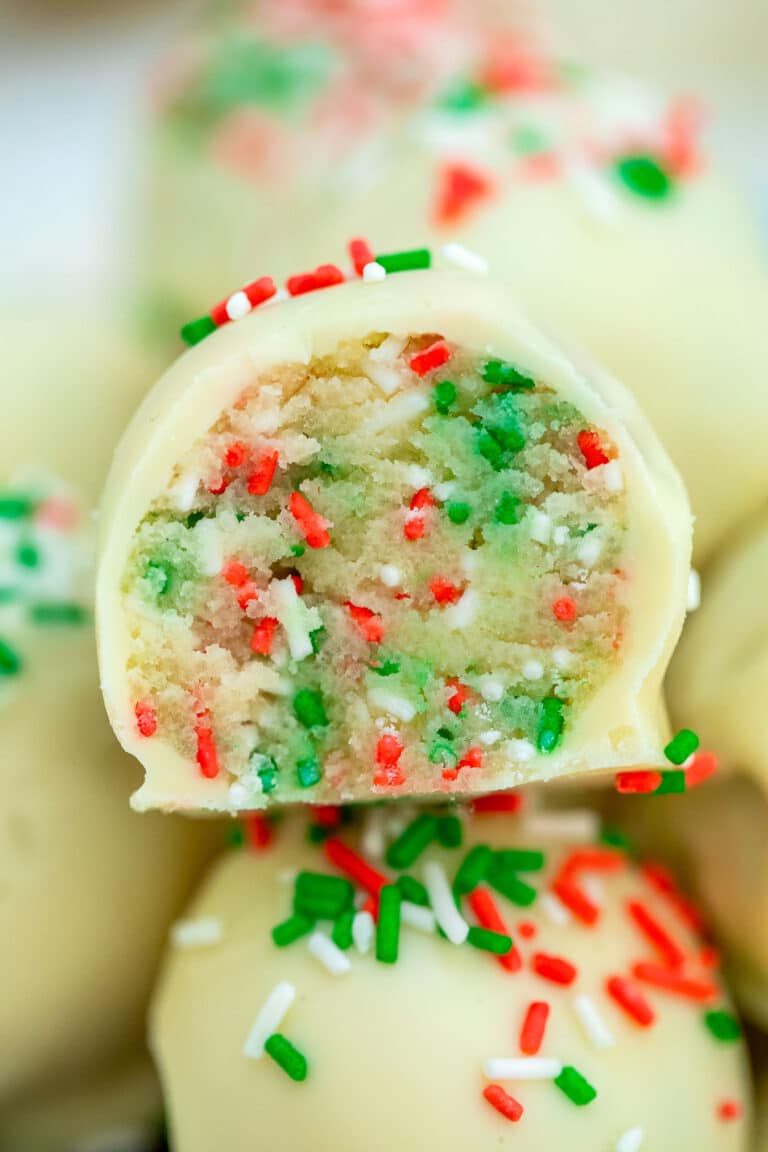 Sugar Cookie Truffles are made with cake mix and coated in delicious white chocolate, topped with Christmas sprinkles. #nobakedesserts #sugarcookies #christmasrecipes #christmasdesserts #sweetandsavorymeals