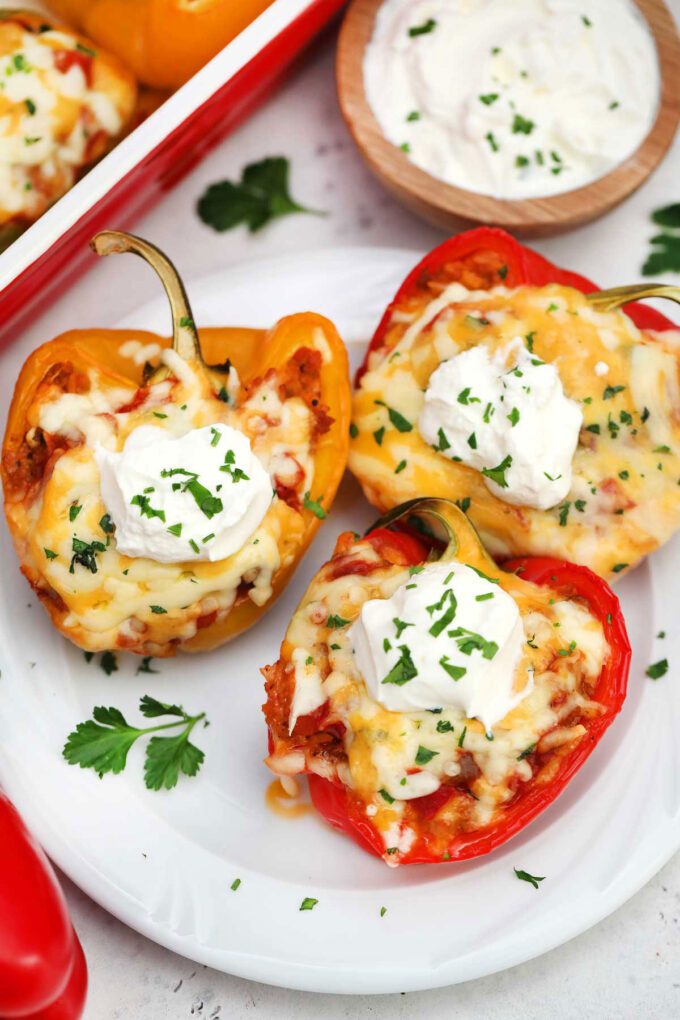 Mexican stuffed peppers with sour cream on a plate