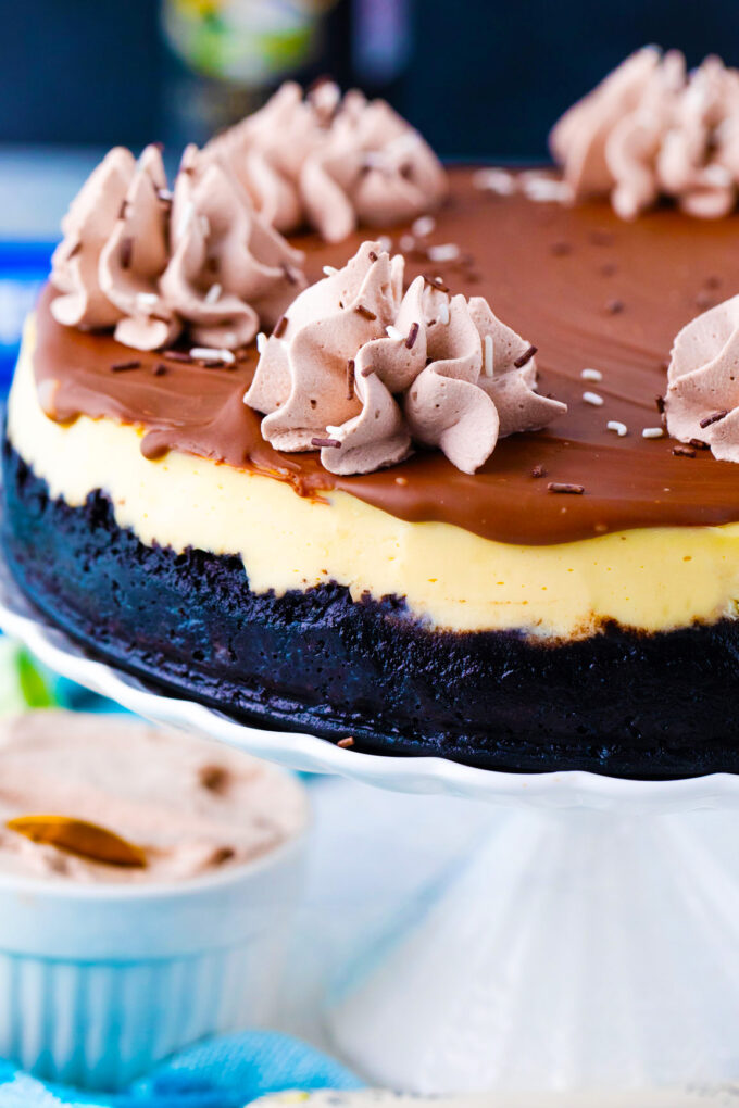Homemade Bailey's cheesecake topped with Bailey's chocolate ganache, and Bailey's whipped cream.