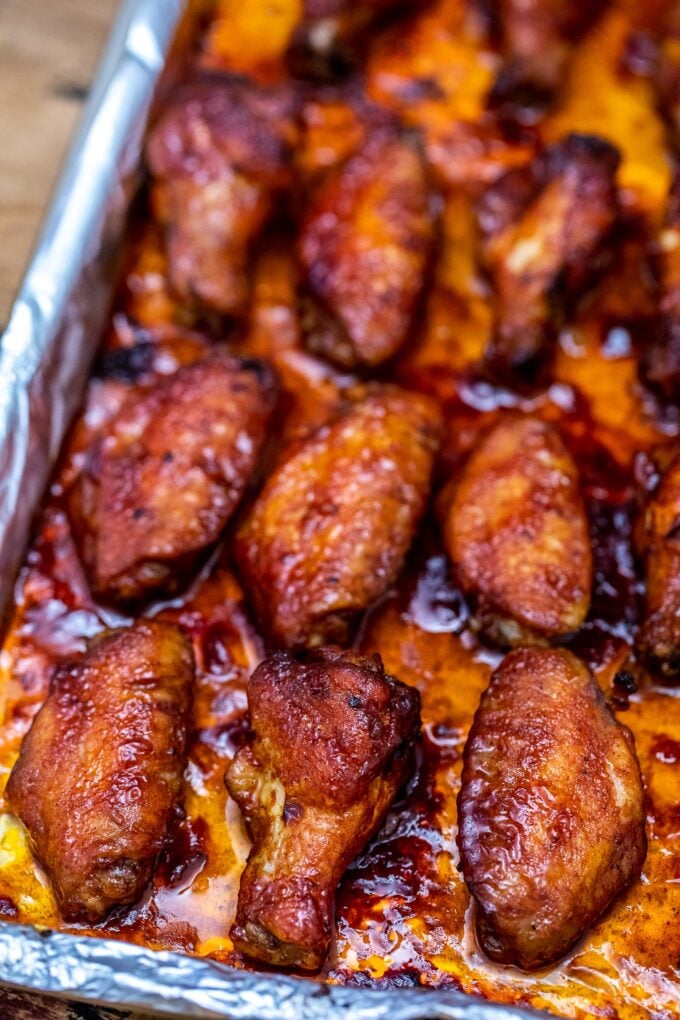 baked honey garlic chicken wings on a baking sheet covered with aluminum foil