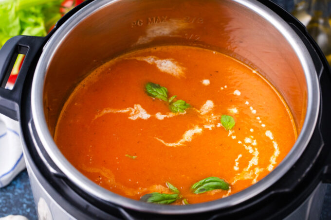 Instant Pot tomato bisque topped with basil.