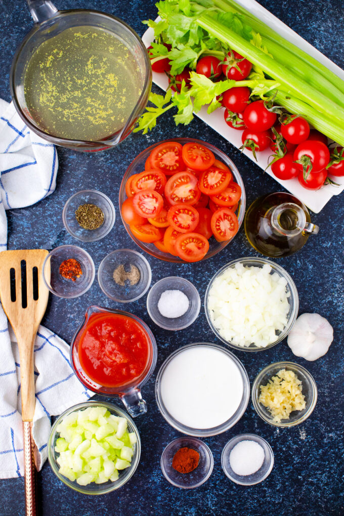 Instant Pot tomato bisque ingredients in bowls on a table.