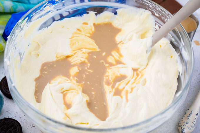 Adding Bailey's to cheesecake batter.