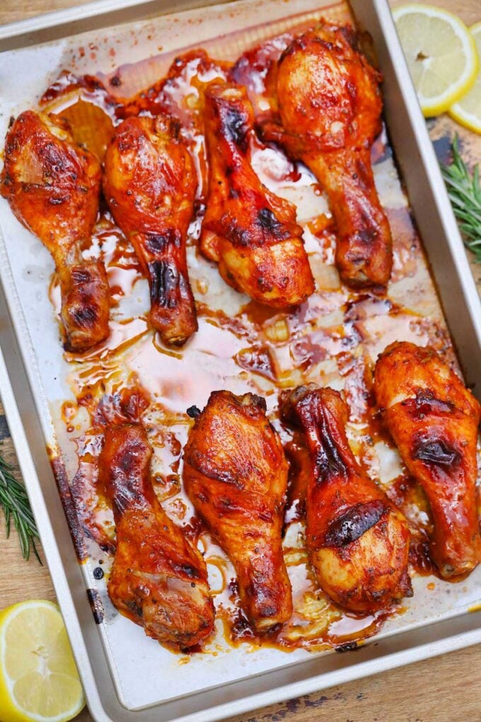 Roasted crispy chicken drumsticks on a cooking sheet