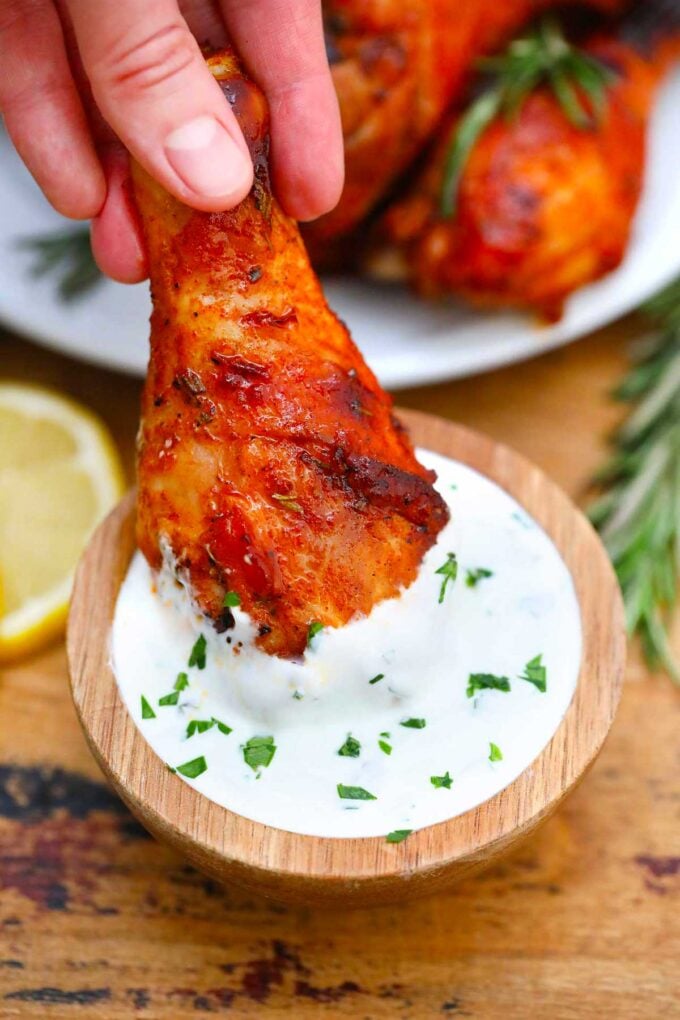 Baked chicken legs in a white dipping sauce