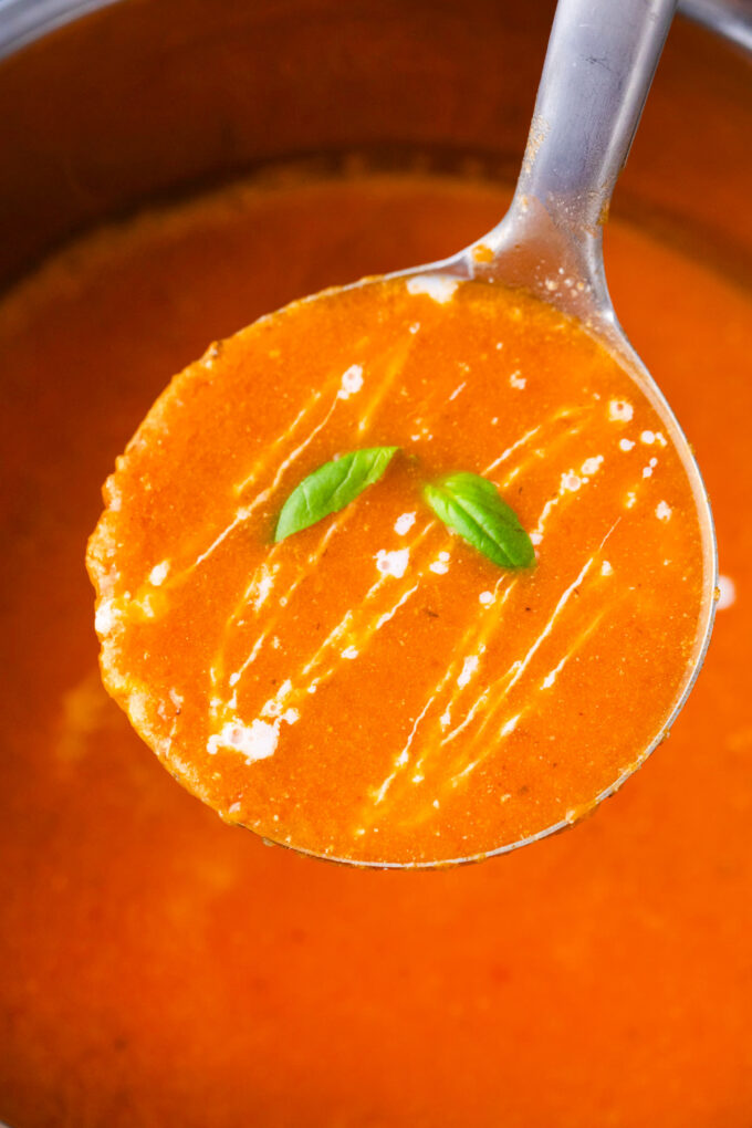 A ladle of creamy Instant Pot tomato bisque.