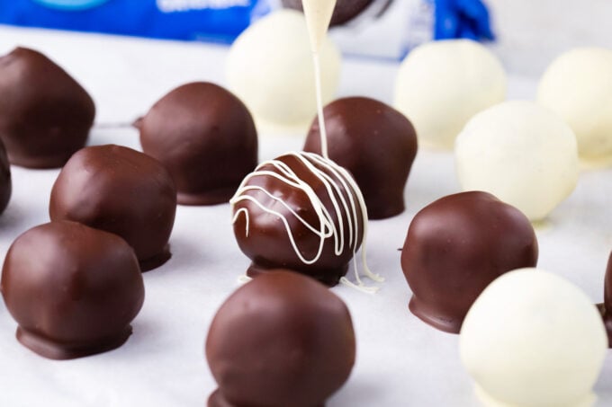 Drizzling chocolate over Oreo balls.