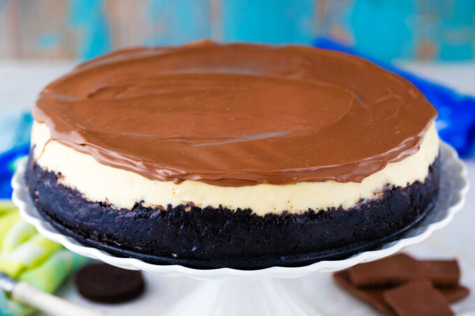 Homemade Bailey's cheesecake topped with chocolate ganache.
