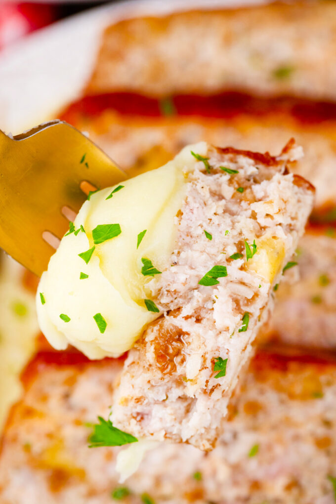 A bite of homemade turkey meatloaf with Pepper Jack cheese.