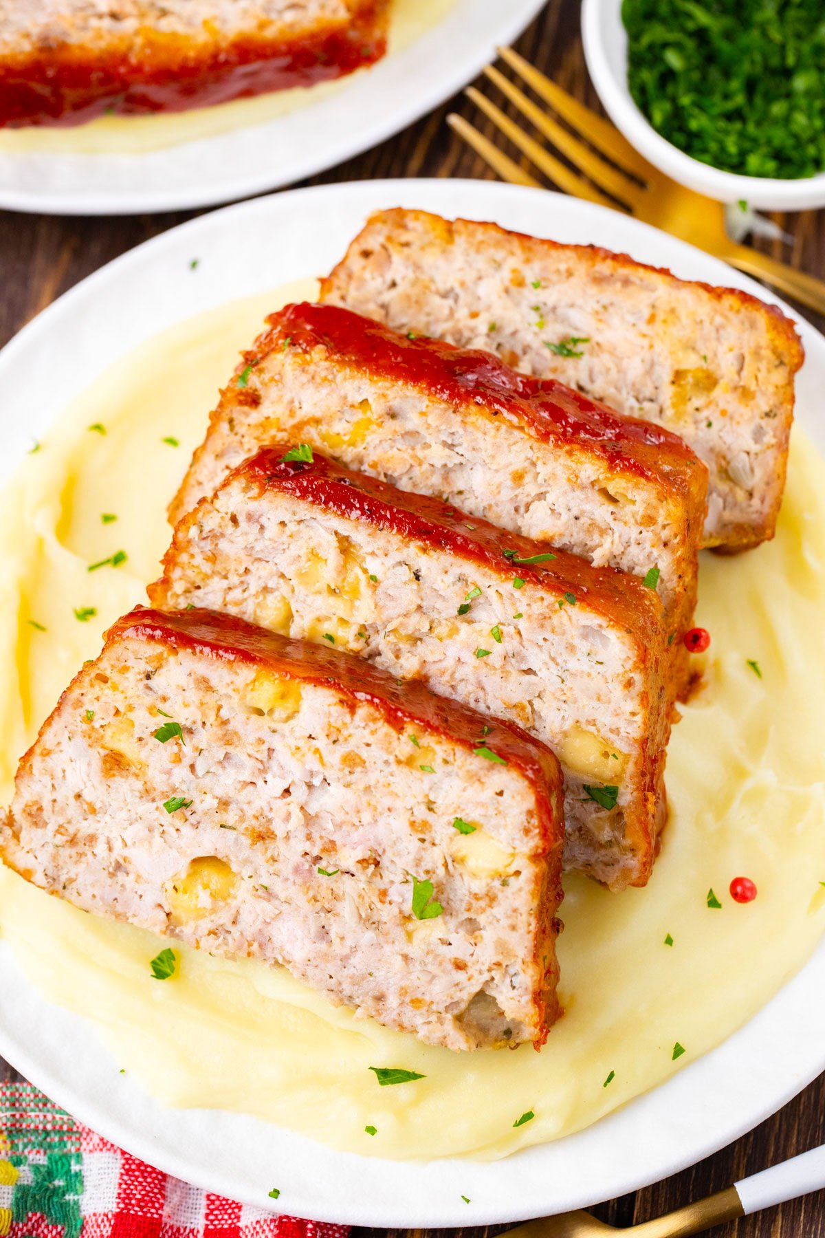 Sliced cheesy turkey meatloaf with Pepper Jack cheese over mashed potatoes.