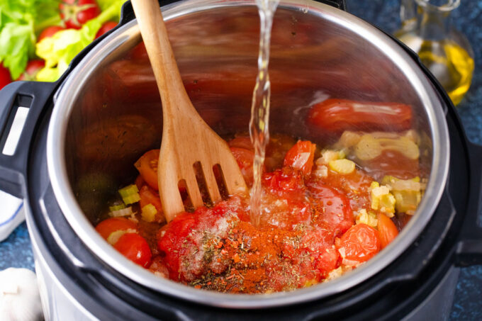 Adding tomato bisque ingredients to the Instant Pot.