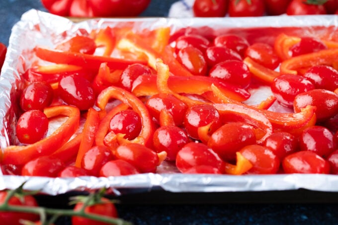 Roasting cherry tomatoes and red bell peppers.