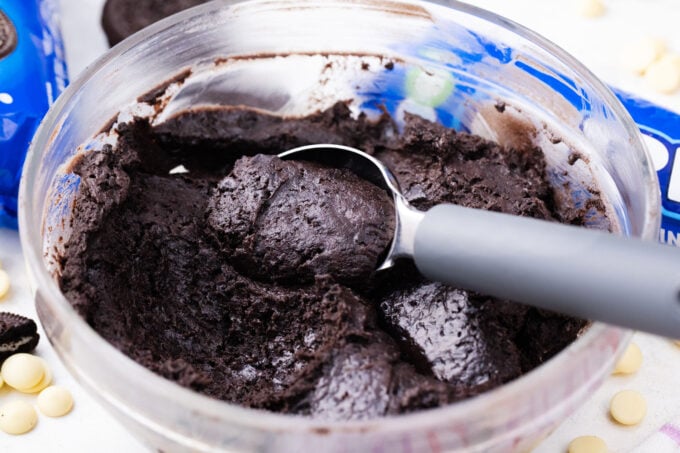 Scooping mixture to roll into Oreo balls.