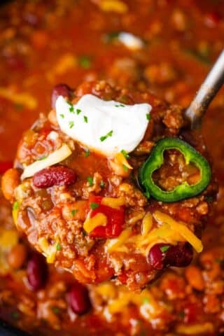 a ladle of cheesy slow cooker Wendy's chili copy