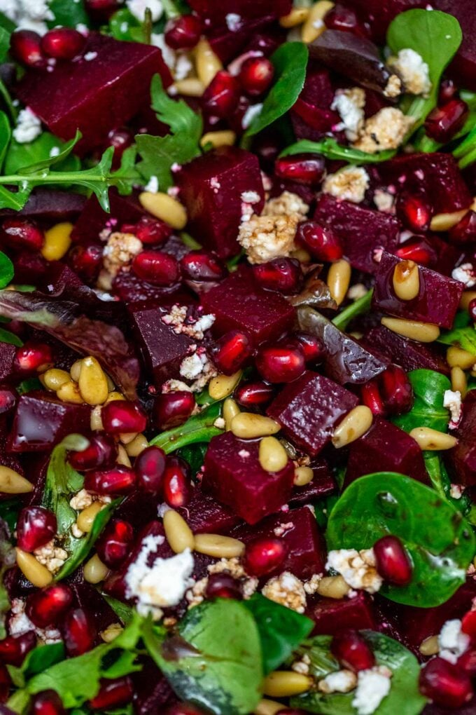 photo of beet salad with spinach pomegranate arils and pine nuts